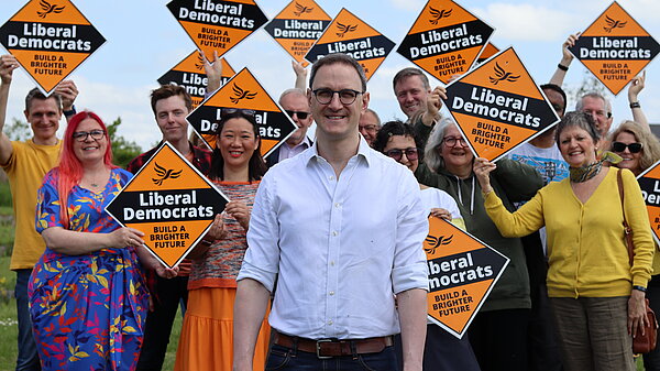 Ian Sollom with volunteers in the background