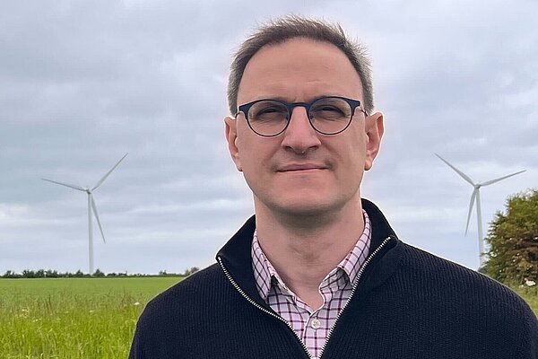 Ian Sollom standing in a field